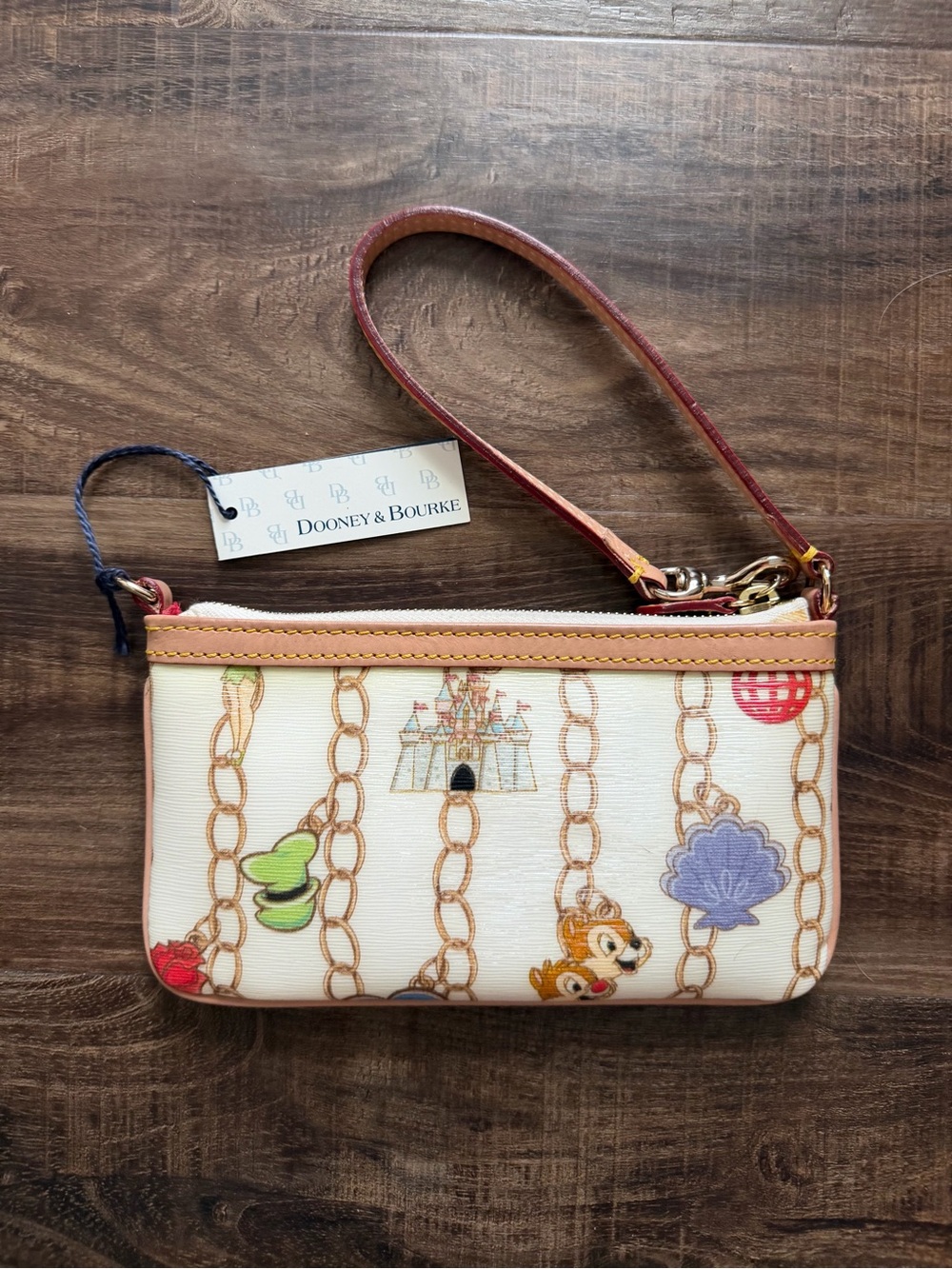 Dooney & Bourke Disney Cream Wristlet w/ Multicolor Charm Print, Like New w/tags - Picture 2 of 7